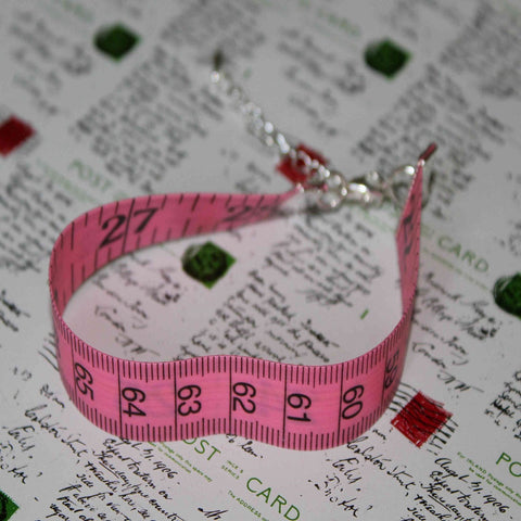 pink tape measure bracelet