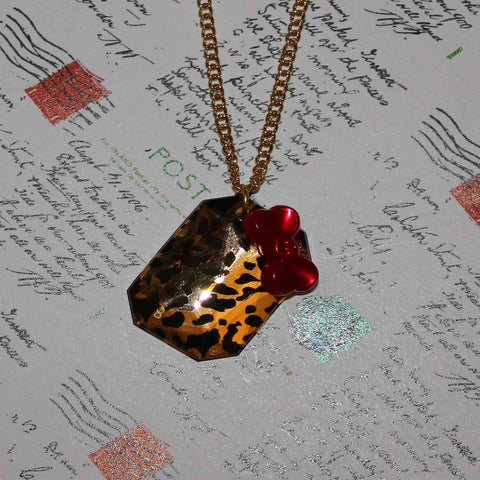 leopard print tile with red bow necklace